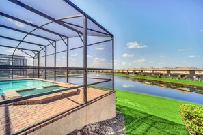 Screened heated pool and spa with lake view