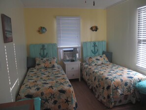 Owner made headboards with a new coat of yellow paint on the wall.