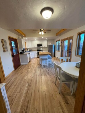 Large kitchen with kitchen table and bar to sit for meals and entertaining