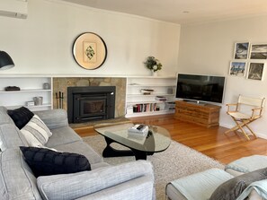 The beautiful open plan living room with french doors to the outside deck.