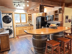 Kitchen newly remodeled in 2024 - added full stove, fridge, and washer / dryer