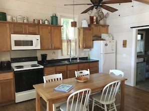 Oak farm table and kitchen area.