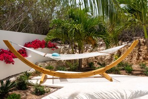 Lounge in the hammock under the swaying palm trees