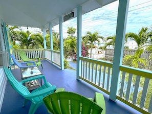 Relax on the shaded front porch with views of the beautiful garden.