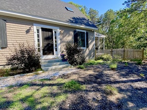 Front view of house. Another entrance into gated backyard from front yard