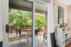 Enjoy coffee or a meal on the balcony. The grass is on the side & building front