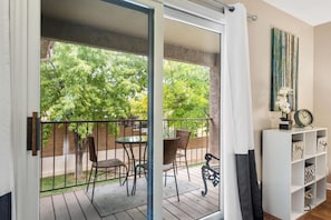 Enjoy coffee or a meal on the balcony. The grass is on the side & building front