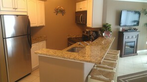 kitchen area w/ four bar stools