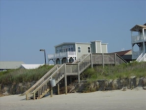 Public stairs over dunes, then 1-way street, house