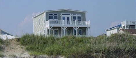 House is beyond dune & sand covered 1 way street