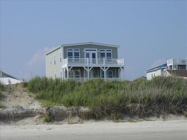 House is beyond dune & sand covered 1 way street