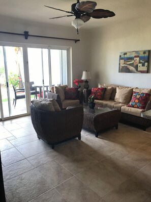 Living Room with patio doors leading to patio, pool and beach