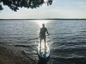 There is a canoe, kayaks and a paddleboard