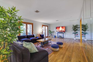 Upstairs living room with balcony entrance and opens to library