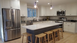 Custom kitchen with island capable of sitting 5