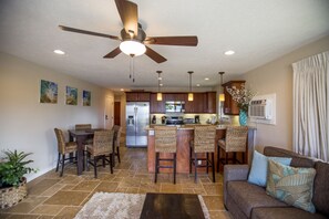 Kitchen, bar, and dining area