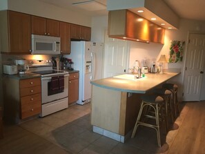 Well stocked kitchen with washer & dryer behind the door.  