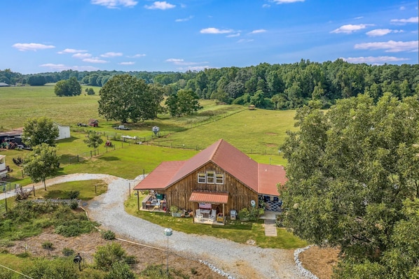 Aerial view of front of the Rustic Retreat and surrounding farm.