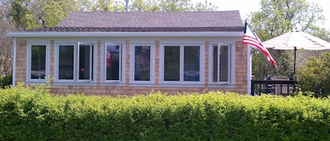 Front of house has a wall of glass windows