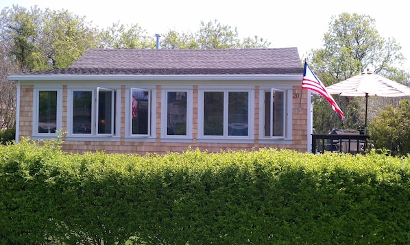 Front of house has a wall of glass windows