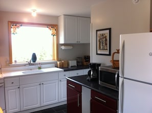 Kitchen, full size fridge, microwave, coffee maker, toaster.  Forest view.