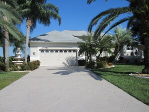 Beautifully landscaped, with mature canary palms