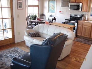 Living area with dining and kitchen in rear of photo