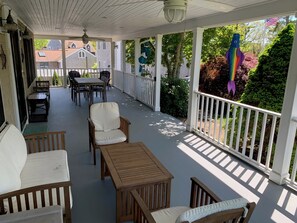 Front porch with seating area overlooking lawn