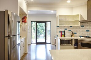 View from the kitchen through the hallway to the private garden path