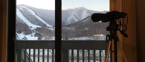 Kitchen Table with Balcony behind.  See snowcats grooming the trails at night. 