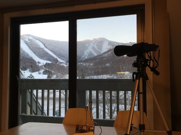 Kitchen Table with Balcony behind.  See snowcats grooming the trails at night. 
