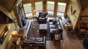 Living room with vaulted ceiling and fireplace