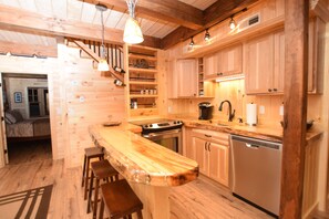 Kitchen with electric stove, dishwasher, fridge, micro, coffee maker and more. 