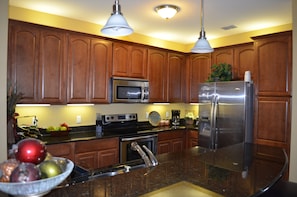 Fully equipped kitchen with marble counters and stainless steel appliances