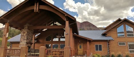 Massive outdoor living porch has woodburning fireplace, sitting area, 14' table.