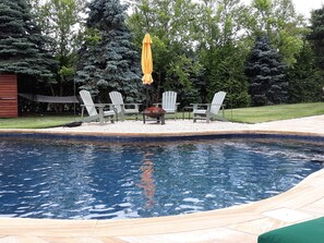 Adirondacks & umbrella overlooking the lagoon shaped pool, tree lined privacy