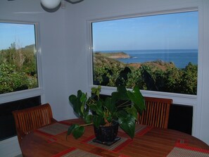 The west end of the house is a beautiful dining area w/ windows on three sides.