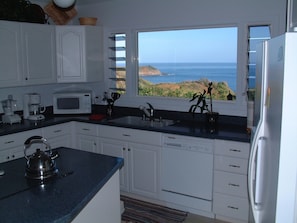 Enjoy wide ocean views from the well appointed kitchen w/ adjacent dining area.