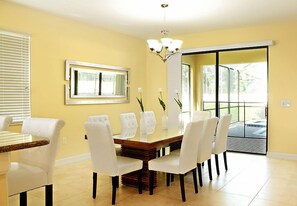 Dining area seating 8 with additional seating for 4 at the counter with stools