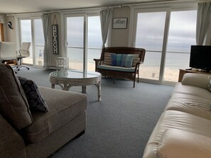Living room w/ glass wall 18ft sliders panoramic view overlooking private  beach