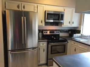 Kitchen with all new stainless steel appliances and all the cooking essentials.