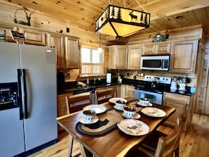 The Kitchen is well appointed with Granite Counters, Stainless Steel Appliances, and everything you will need to prepare and serve your meals at the cabin