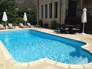 Private pool with sunloungers and outdoor dining table & chairs and barbeque