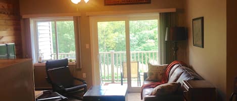 Living room with balcony facing south peak ski trails of Loon mountain.