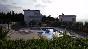View of the villa from the opposite end of the site's shared pool