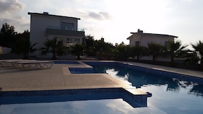 Pool area, 16m by 4m with 2 small splash pools & lovely sea views beyond