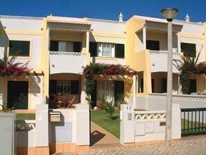 Holiday villa front view and garden entrance gate.