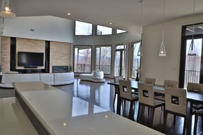 Dining room table and living room view from the bar with dynamic lighting