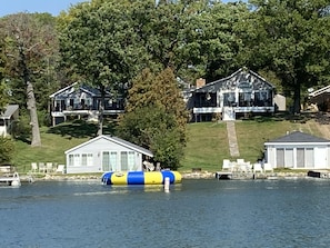 View of sister villas and their boathouses and beaches looking from boat