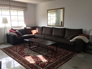 Large, beautiful corner sofa in the living room.